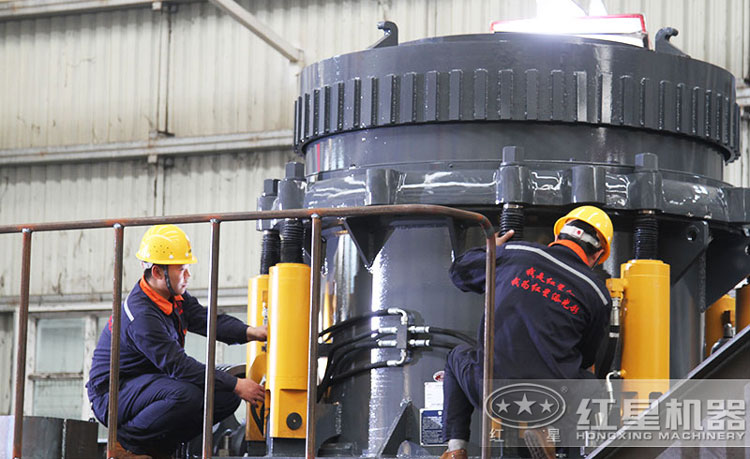 工作人員檢測圓錐破碎機(jī)，保障生產(chǎn)的設(shè)備都有高質(zhì)量